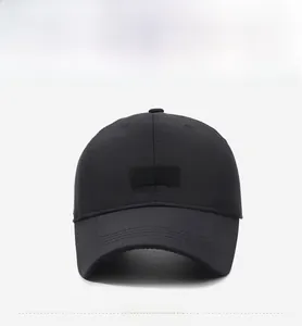 Close-up of black cotton baseball cap featuring embroidered lion head patch and white text