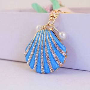 Blue enamel shell keychain with rhinestones, gold plating, and elegant pearl accents