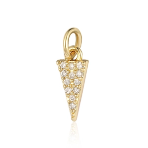 Macro detail of a golden triangle pendant with inlaid zircons and clear reflections