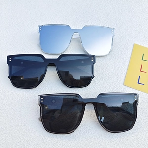 Three colors of oversized wrap-around sunglasses on a textured white background