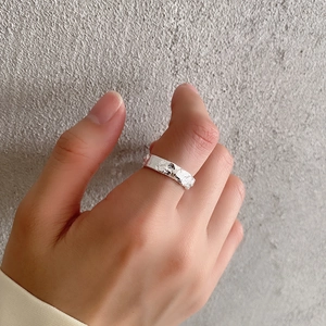 Close-up of 925 sterling silver ring with irregular hammered texture on female finger