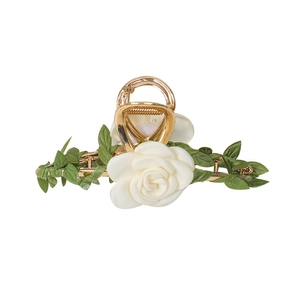 Elegant gold alloy hair claw clip with white fabric rose and green leaves on white background