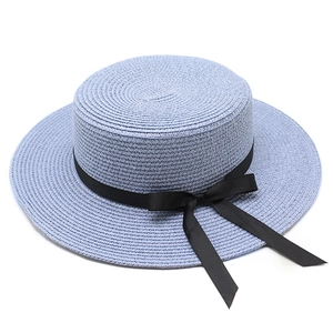 Détails de la texture du chapeau canotier bleu clair avec ruban gros-grain noir