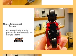 Detail of red and black mini motorcycle model toy showing the bottom structure and wheels