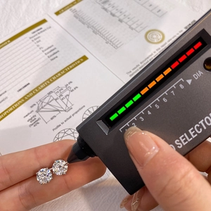 Macro detail of silver moissanite stud earrings being tested with a diamond selector tool