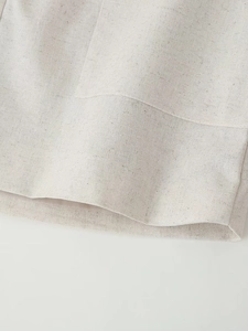 Close-up of beige linen-cotton fabric texture showing natural fiber weave details