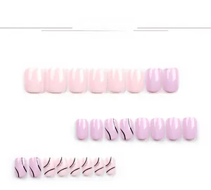 Detail of short square oval press-on nails in pink and purple with minimalist line art