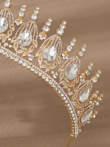 Close-up of golden vintage baroque bridal crown with sparkling white rhinestones and crystals