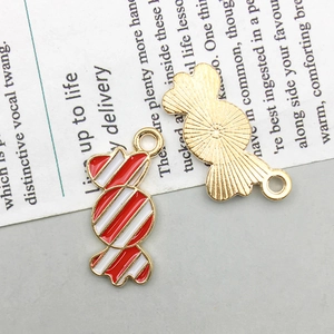 Detail of candy-shaped enamel pendants with red and white stripes for DIY jewelry making