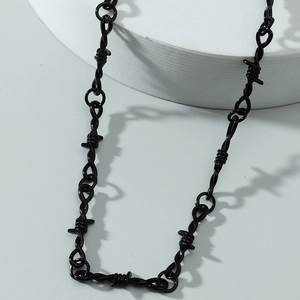 Punk style black thorn necklace in gothic thorn design on a white minimalist background