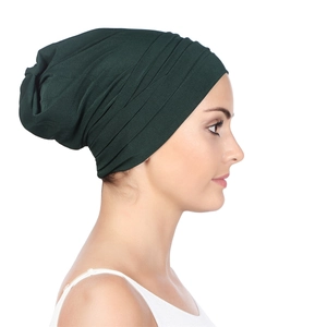 Side view of dark green pleated turban hat for women showing soft fabric details