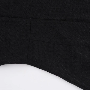 Close-up of black textured fabric and neat stitching on a fitted square-neck dress