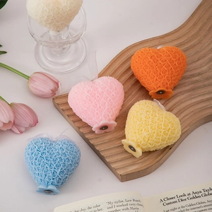 Close-up of heart-shaped rose scented candles with intricate floral textures in various colors