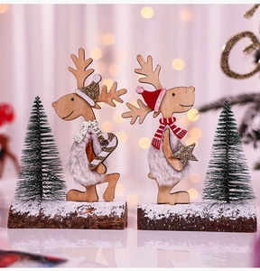 Detail of wooden reindeer ornaments with faux fur and mini cedar trees on a base