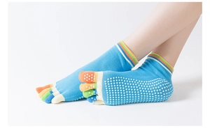 Detailed view of rainbow-striped toe socks with anti-slip white silicone grip dots on the sole