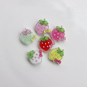Detailed view of 20x21mm colorful resin strawberry charms with bows for DIY crafts