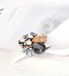 Macro shot of vintage crystal brooch with amber pear-cut stones on a white prop