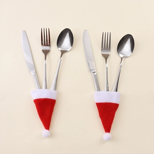 Detailed view of mini Christmas hat cutlery holders with stainless steel knife and fork