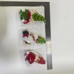 Size measurement of gnome wine bottle covers with striped scarves in plastic packaging
