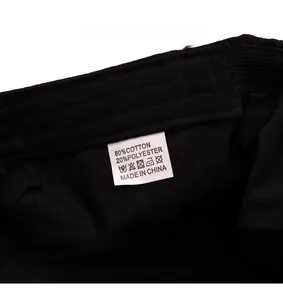Close-up of the care label showing 80% cotton and 20% polyester material on the newsboy cap
