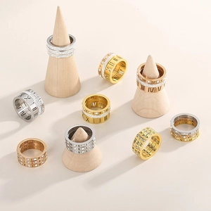 Detail view of Roman numeral rings with crystals on wooden cones in a warm setting
