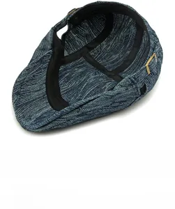 Detail of dark blue vintage flat cap showing woven texture and adjustable metal buckle
