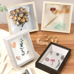 Wooden shadow box frame set with dried flowers and natural botanical specimens