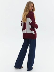 Back view of burgundy oversize knit sweater with large white LE letter jacquard design