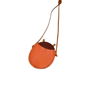 Cute round kids crossbody bag with orange leather texture and brown ear details