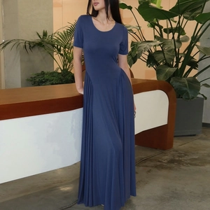 Detail of navy blue U-neck dress showing waist pleats and soft fabric texture
