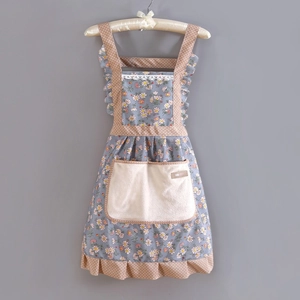 Detail of floral kitchen apron featuring khaki polka dot ruffles and a large beige pocket