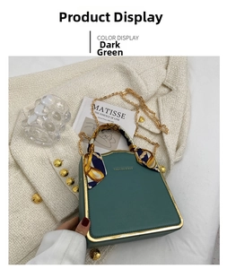 Detail of dark green chain bag with silk scarf handle and golden metal frame