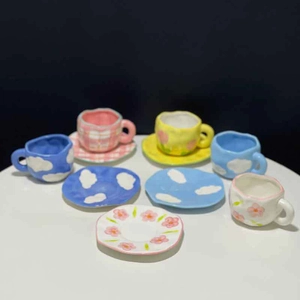 Hand-painted ceramic tulip and cloud coffee mug and saucer set with irregular edges