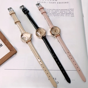 Detailed view of three luxury quartz watches with pink, black, and beige leather straps