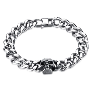 Close-up of polished silver punk cuban link chain with detailed skull charm buckle