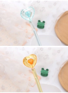 Detail of creative crystal heart-shaped pens in cyan and yellow colors for students