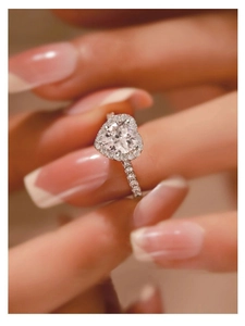 Close-up of a heart-shaped moissanite ring with halo setting on S925 silver band