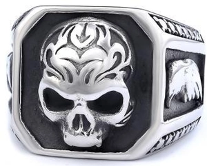 Detailed macro view of vintage punk skull ring with silver and black textured finish