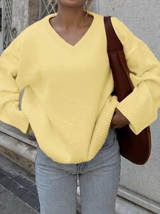 Chic v-neck long sleeve knit sweater in yellow styled with light blue denim jeans