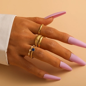 Close-up of elegant gold titanium steel ring set with blue gems worn by a model