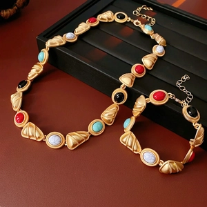 Vintage jewelry set with triangular beaded necklace and bracelet in golden finish