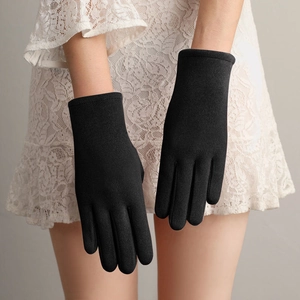 Elegant black winter gloves for women paired with a delicate white lace sleeve