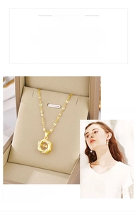 Detail of gold heart necklace with spinning center stone in a premium jewelry box