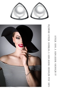 Detail showing high-quality white freshwater pearl on silver triangle earring with model