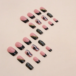 Elegant black and pink press-on nails with gold foil accents and leaf patterns
