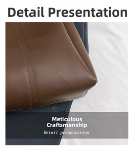 Close-up of fine stitching and matte leather texture on dark brown tote bag corner
