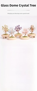 Detail view of handmade natural crystal tree set in a glass dome with wooden base