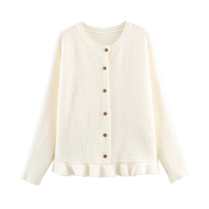 Detail of cream knit cardigan featuring scalloped hem and square brown buttons