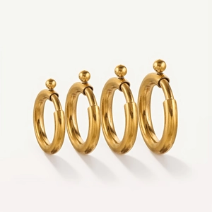 Detailed view of four golden stainless steel spring ring clasps in increasing sizes
