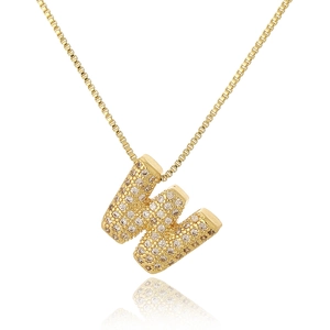 Macro shot of gold-plated letter W pendant encrusted with clear cubic zirconia crystals